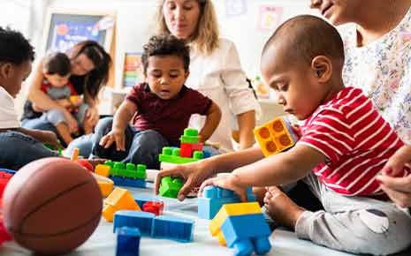 babies playing with building blocks